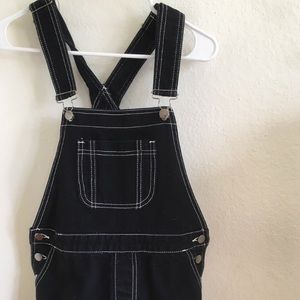 Black denim overall shorts with white stitching